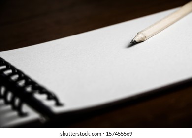 Close Up Classic Wood Pencil With Blank White Paper On Wooden Background.Still Life Photography.