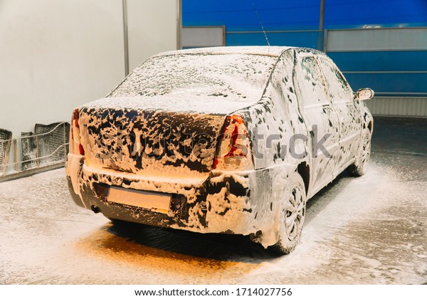 Close up clean car concept at car wash. Washing car\
with soap. Car wash