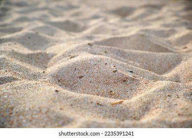 Close up of clean yellow sand surface covering seaside beach illuminated with day light. Travel and vacations concept - Shutterstock ID 2235391241