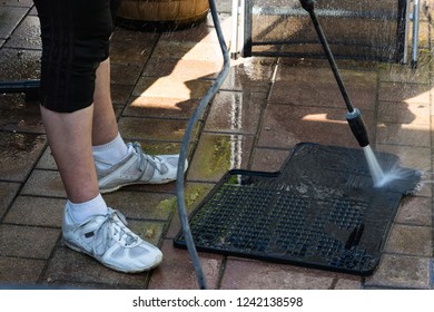 Close Up Cleaning Of Car Mat With A Pressure Washer