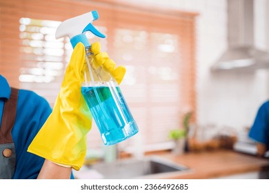Close up cleaning service woman worker hand working in house. Girls housekeeper cleaner, holding foggy spray with liquid detergent, rag with a smile, looking at camera after finish chore. - Shutterstock ID 2366492685