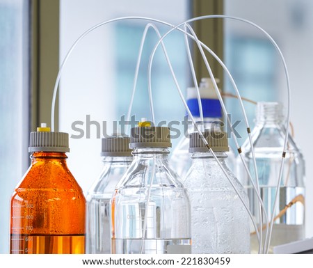 Close up clear and amber color bottle with plastic hose for High performance liquid chromatography - HPLC