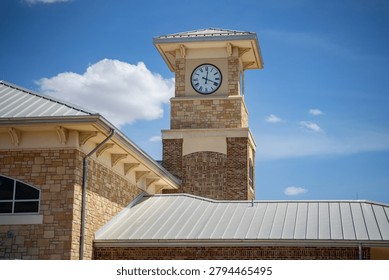Close Up of Clock Tower on Brick and Stone Building With Blue Sky
