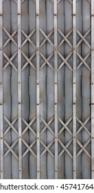 Close up Closed Grey Metallic Sliding Grille Door of Grocery Store