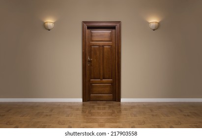 Close up of closed wooden door in the empty room with copy space - Shutterstock ID 217903558