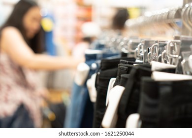 Close Up Clothes Hangers On Rack With Anti Theft Alarm. Background For Fashion Retail Shop Shop And Apparel Store.