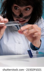 Close Up Of Clumsy Mad Chemist Mixing Chemical Substances To Create New Formula By Using Unknown Compounds. Funny Looking Crazy Scientist Experimenting With Toxic Fluids Resulted From Lab Explosion