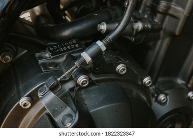 A Close Up Of The Clutch Cable On A Motorcycle Engine