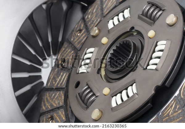 Close up of\
clutch disc of manual gearbox car, selective focus. Car clutch\
repair kit. Automotive spare\
parts.