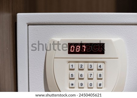 Close up code lock on the safe door.Safe for customer in hotel room.Press key on safety lock number.Safety and security concept.
