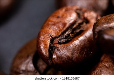 Close up of a coffee bean.
Macro photography of coffee beans in high resolution. Very detailed sharp ultra macro on a roasted coffee bean.  Microscopic photography. Perfect desktop background picture
