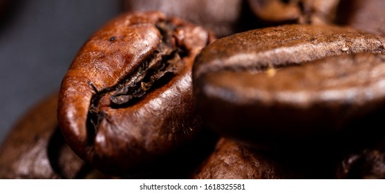 Close up of a coffee bean.
Macro photography of coffee beans in high resolution. Detailed ultra macro on a roasted coffee bean.  Microscopic photography. Useful as a desktop background picture
