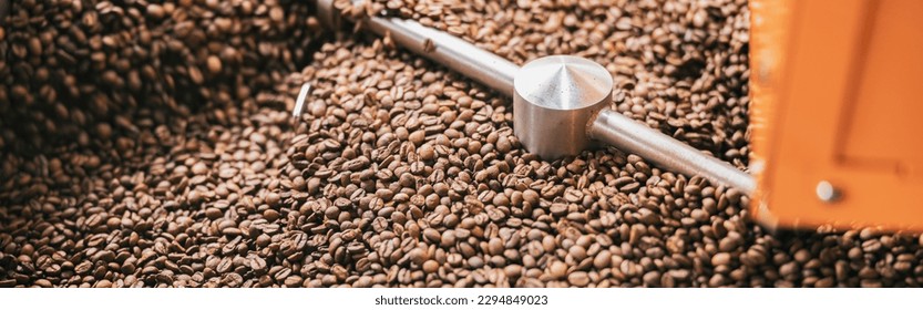Close up of coffee beans in coffee roasting machine in a small manufacturing