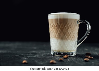 Close Up Coffee Drink In A Glass Mug. Latte With Salted Caramel. Black Background. Copy Space