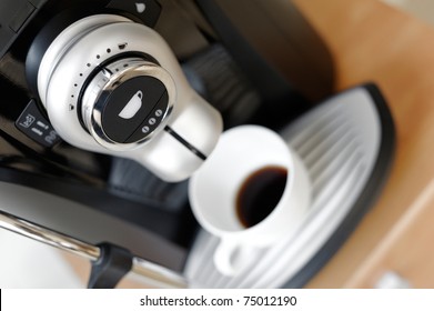 Close Up Coffee Maker Machine With White Coffee Cup. Great Abstract View For Your Office Life Brochure, Restaurant And Other Place Advertising.