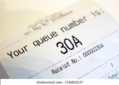 Close Up Of Coffee Receipt Slip With Queue Number On It.