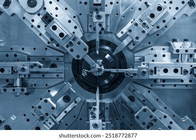 Close up the coil spring making machine in light blue scene. The mechanical parts manufacturing concept.