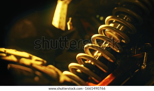 Close up of coil spring used as a part\
of car or motorcycle suspension system. Stock footage. Details of\
machines, professional equipment and repair\
parts.
