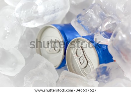 Close Up of Cola Cans in Ice