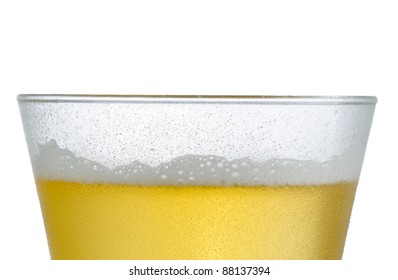 Close Up Of A Cold Frosted Pilsner Beer Glass With Light Beer And Little Head Below Rim Level