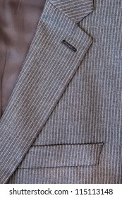 Close Up Of The Collar And Breast Pocket Of A Pin Stripe Suit