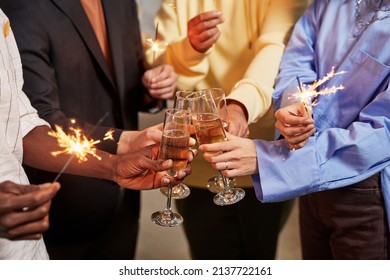 Close up of colleague lighting sparklers while celebrating Birthday in office - Powered by Shutterstock