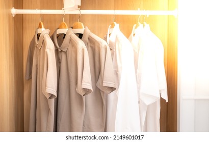 Close Up Collection Shade Of Earth Tone Color T-shirts Hanging On A Wooden Clothes Hanger In Closet Or Clothing Rack. 