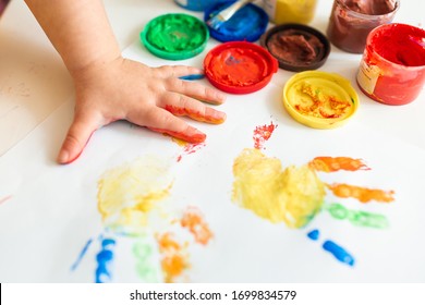 Close up colored hand print white background  Ideas for drawing and finger paints  Finger painting for kids  Little girl painting by finger hand paint color  Children development concept 