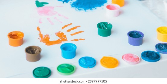 Close up of colored hand print on white background. Ideas for drawing with finger paints. Finger painting for kids. Little girl painting by finger hand paint color. Children development concept. - Powered by Shutterstock