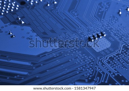 Close up of colored micro circuit board. Abstract technology background. phantom classic blue color
