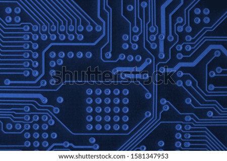 Close up of colored micro circuit board. Abstract technology background. phantom classic blue color