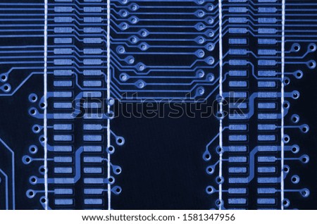 Close up of colored micro circuit board. Abstract technology background. phantom classic blue color