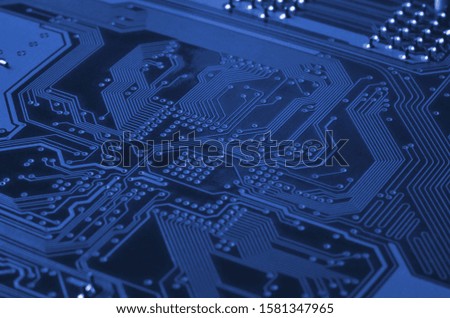 Close up of colored micro circuit board. Abstract technology background. phantom classic blue color