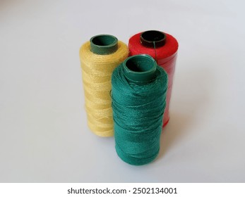 close up of colored thread spool isolated on white