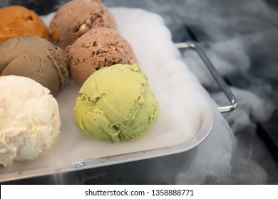 Close Up Of Colorful Ice-cream With Dry Ice In The Black Table 