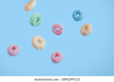  close up colorful loops of fruit grains in flight on a blue background. Colorful breakfast food. High quality photo - Powered by Shutterstock