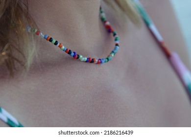 Close Up Of Colorful Plastic Beads Necklace On Woman Neck