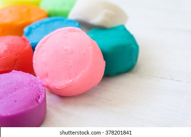 close up of colorful playdough on wooden table. - Powered by Shutterstock