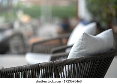 Close Up Colorful Soft Pillows Cushion Arrange On Nature Material Dining Chair With Blur Patio Area Background Interior Design Concept