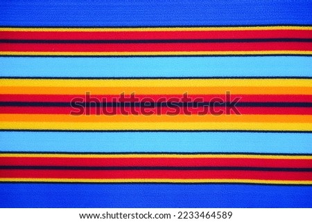 close up of colorful textile fabric texture background.Top view of beautiful colorful fabric texture for background,textile fabric background with blue, yellow, red, orange stripes,colorful background