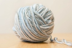 Close Up Colorful Yarn Texture Background, Pastel Blue Gray And White Strains, Coiled In Ball Skein. Knitting And Crochet, Home Craft Work. Shallow Depth Of Focus. Winter Color Combination For Styling