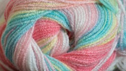 Close Up Colorful Yarn Texture Background, Pastel Blue Green Yellow Pink Purple Brown Gray White Strains Coiled In Ball Skein. Knitting, Crochet, Home Craft Work. Winter Color Combination For Styling.
