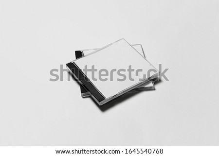 Close compact plastic disc box case with white isolated blank for branding design. CD jewel mock-up on soft gray background. DVD or CD disc