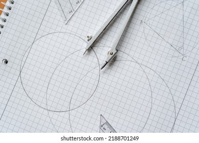Close up Compass and ruler on the open notebook. Mathematical accessories, back to school background