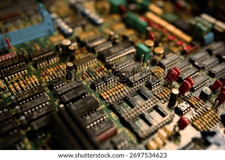 A close up of a computer board with many small components. Concept of complexity and intricacy, as the various parts are densely packed together. The viewer can appreciate the engineering