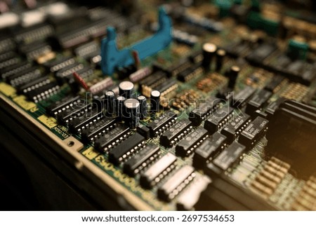 A close up of a computer board with many small components. Concept of complexity and intricacy, as the various parts are densely packed together. The viewer can appreciate the engineering