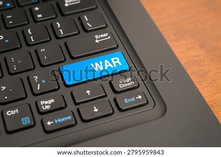 Close up of a computer keyboard with a blue war key, representing military conflict, geopolitical tension, cyber warfare, defense strategies, security risks, and global crisis concepts.