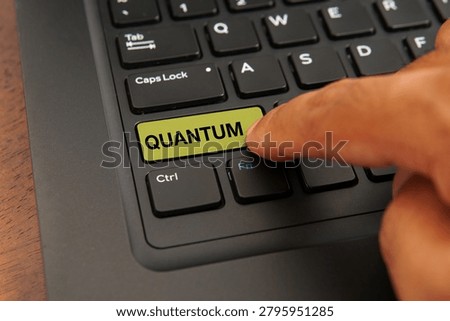 Close up of a computer keyboard with a finger pressing a quantum key, representing quantum computing, advanced technology, future innovation, scientific research, and next-generation digital concepts.
