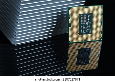 Close up of Computer Processor with Aluminum Heatsink on Black Reflective Background