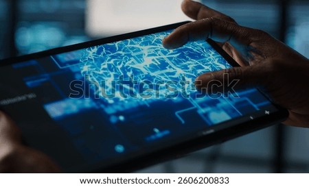 Close up of computer scientist in data center uses AI on tablet, verifying compliance of racks. IT expert using artificial intelligence on device to optimize resource utilization, camera A